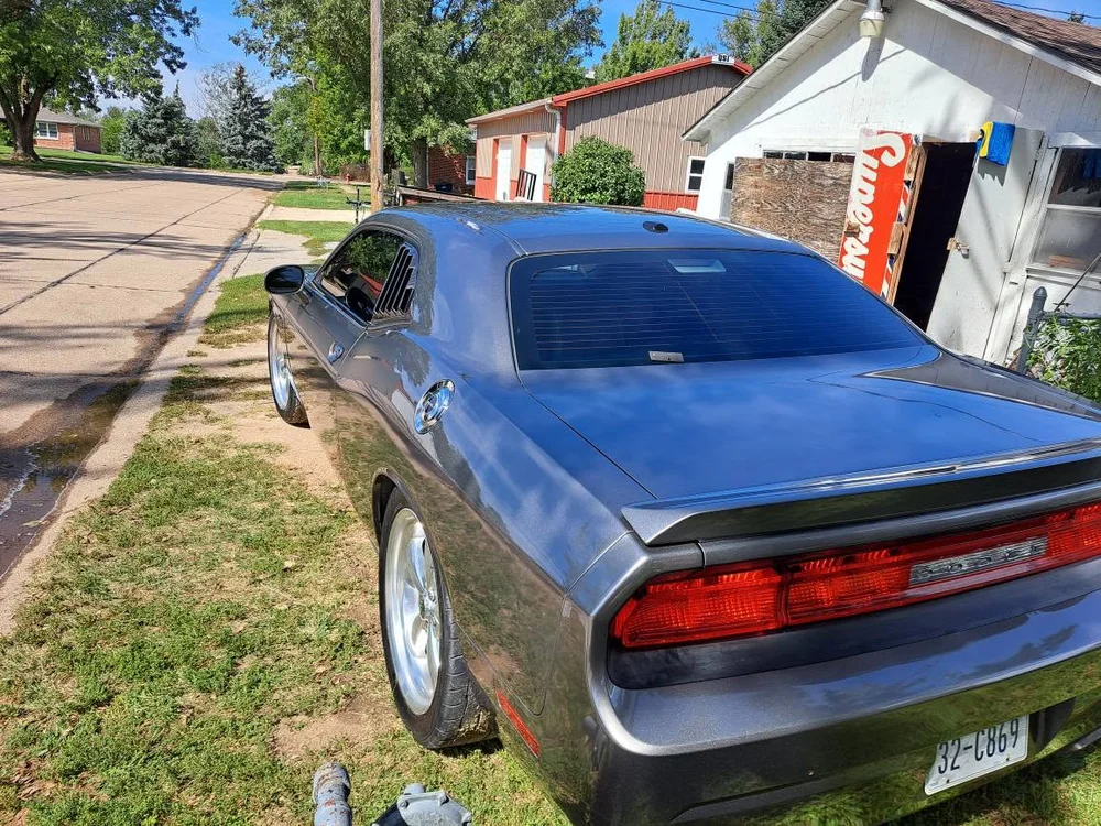 Grey Dodge Challenger detailed on a residential street
